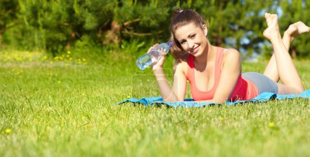 Beautiful happy smiling sport fitness model outside on summer