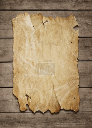 Old paper sheet at wooden wall
