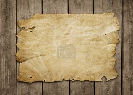 Old paper at grunge wooden background