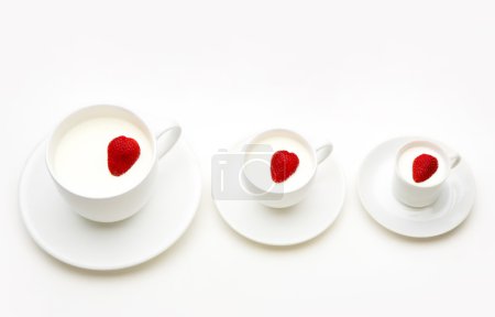 Three white cups of milk