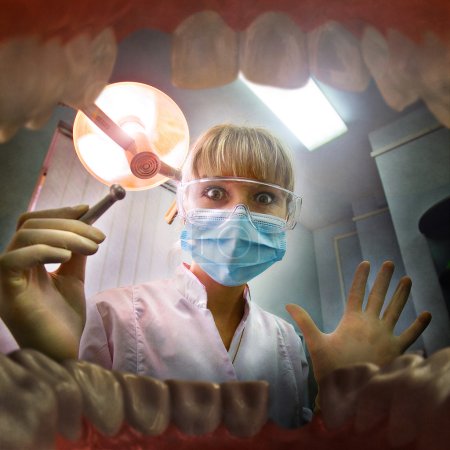 Young female doctor looking inside patient's mouth. View from inside