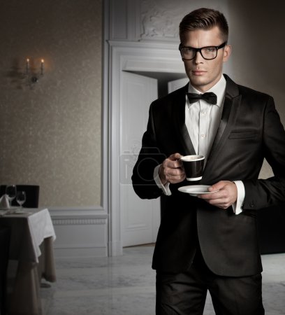 Handsome man with cup of coffee