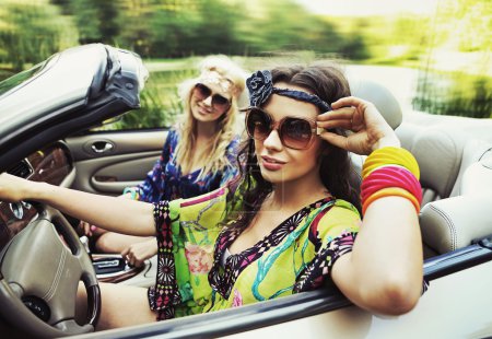 Smiling women in a cabriolet