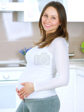 Pregnant Young Woman at home. Happy Pregnancy