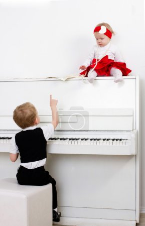 Two kids near the piano